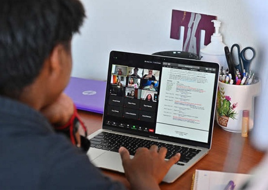 Boy working on his laptop with a virtual therapy session