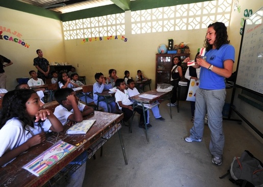 Teacher giving a lesson in a classroom.